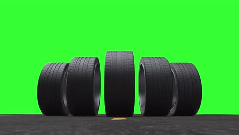 neumáticos de coche de bucle rodando en el asfalto en el verano en un fondo verde