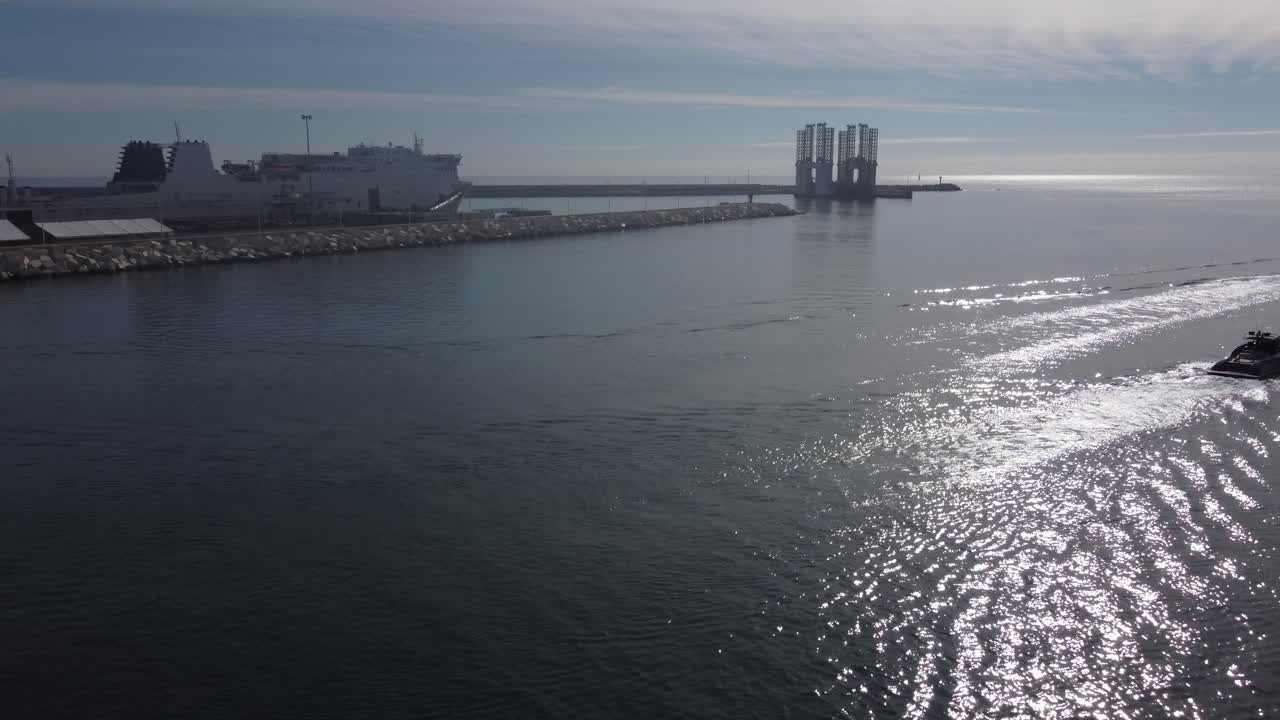 Flying towards three small vessels and a large ferry boat. Alicante, Spain.