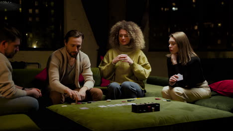 group of friends playing poker sitting on the couch in the living room 1