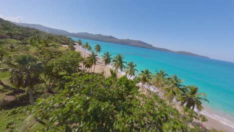 fpv drone flight over tropical island of dominican republic with sandy beach and turquoise caribbean sea in summer