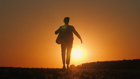 silhouette of a woman walking at sunset