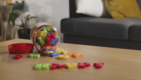 Coloured-Letter-Shape-Toy-On-Table-At-Home-For-Child-Diagnosed-With-ASD-Or-Dyslexia