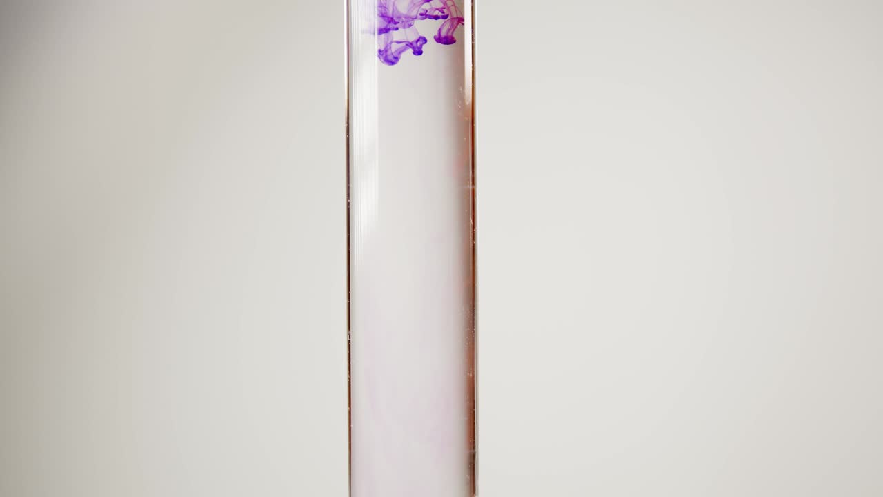 gota de tinte de color en un recipiente de vidrio con agua