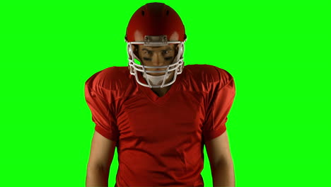 red serious american football player posing