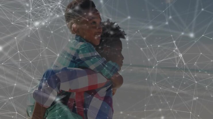 Child climbing onto woman, woman securing legs, walking shore with tech nodes overlaying scene