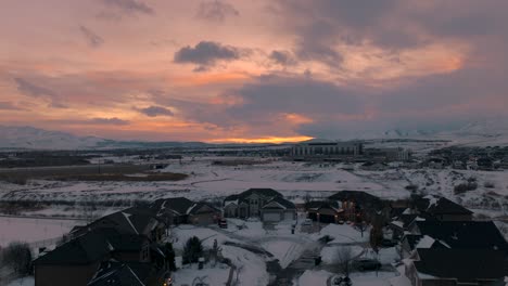 snowy suburb in winter after a snowstorm at sunset - aerial flyover