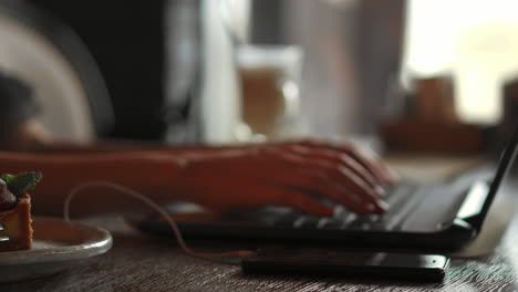 a female programmer typing source codes in a coffee shop with a relaxing working environment. studying, working, technology, freelance work, web design business, and web development concept.