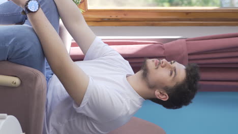 vertical video of christian man praying in front of the window.