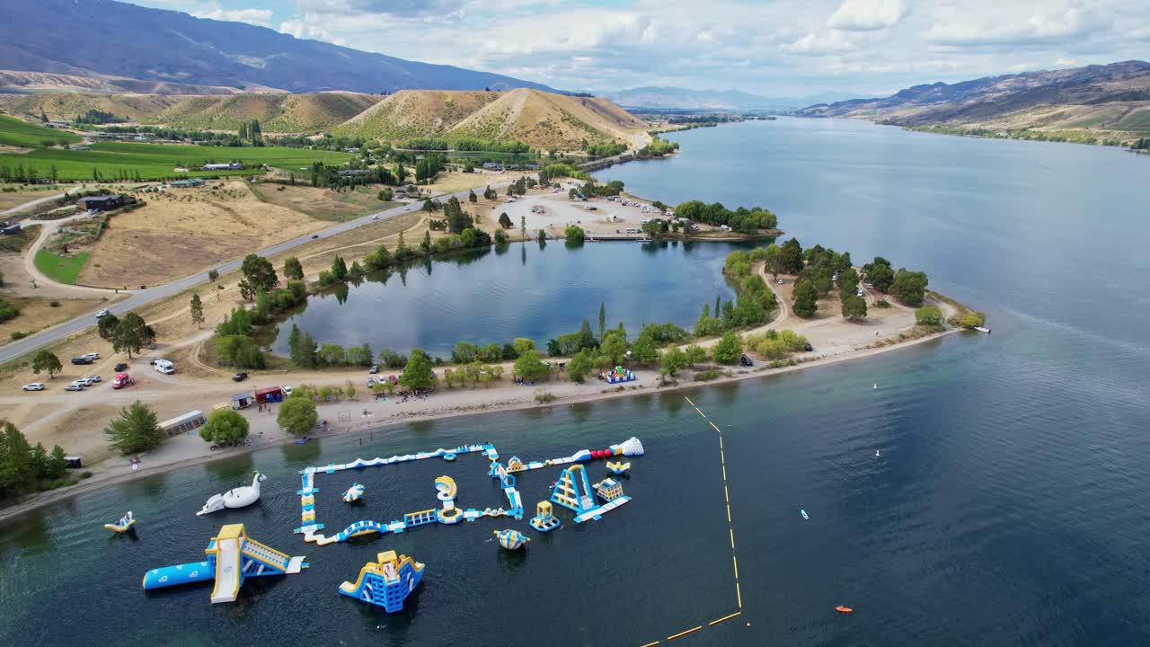 Aerial shot flying above Lake Dunstan water park and nearby peninsula