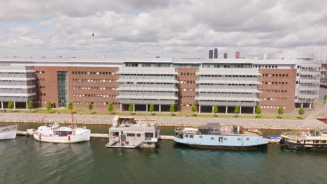 aerial tracking shot of kayaks in middle of boats and buildings in copenhagen