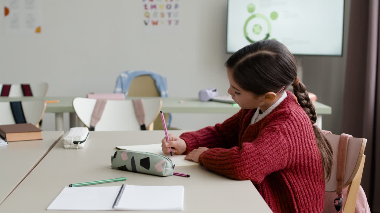 Student Working on Homework in Classroom