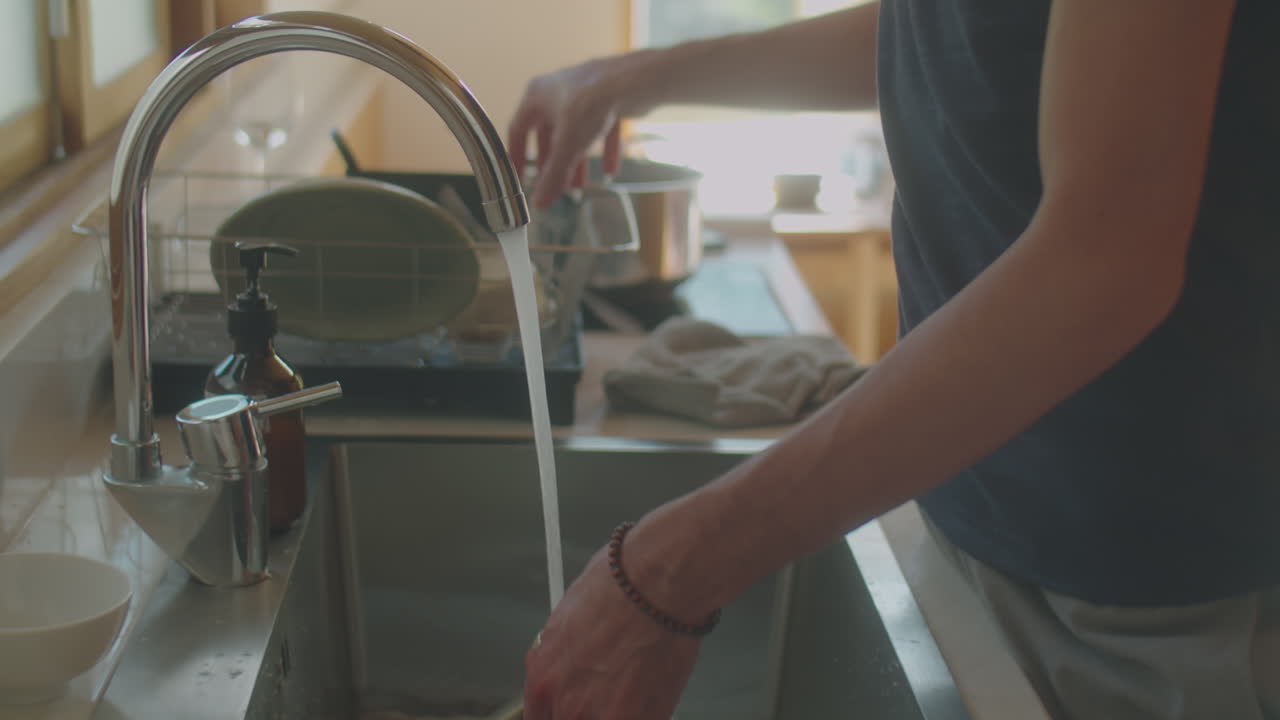 Man Washing Dishes at Home