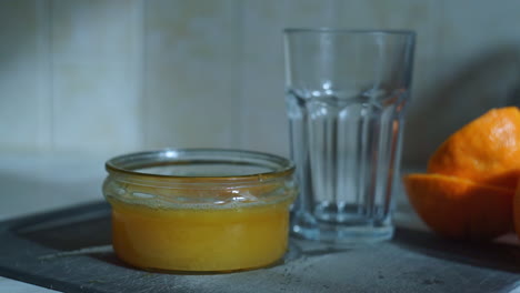 man puts fresh squeezed orange juice in a glass