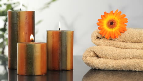 close up on candles, towels and sunflower