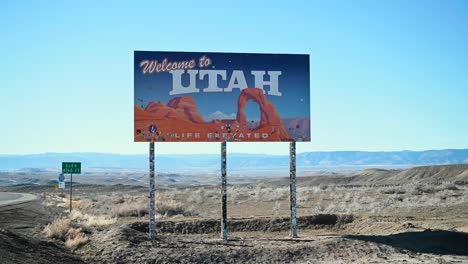 leaving colorado and standing in front of the welcome to utah state line sign, handheld