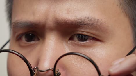 Young-man-perches-frames-on-his-nose-contemplating-the-visual-impact