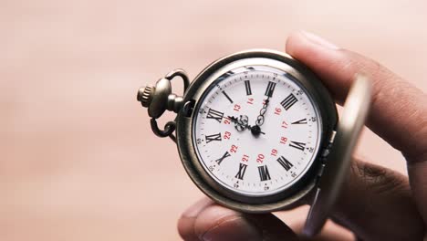 antique pocket watch in hand