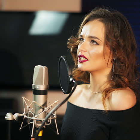 beautiful sexy young woman singing. female vocal. professional recording studio. square video