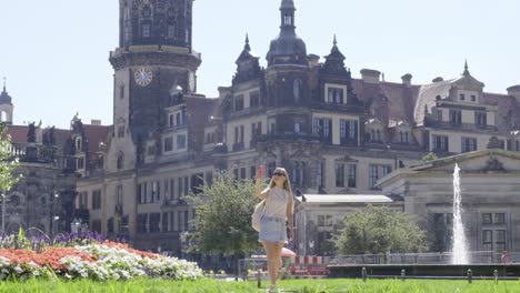 A woman is standing in a park in front of a castle 4k 2025 08 05 01 31 10 utc.mov | adventure, architecture, attraction, beautiful