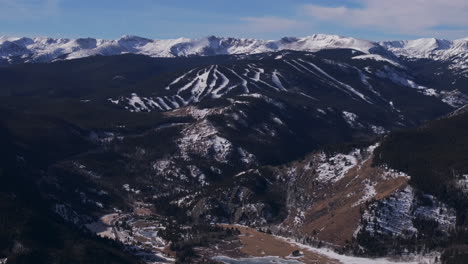 Eldora-Mountain-ski-trail-runs-Indian-Peaks-Woodward-Ikon-Pass-Colorado-cinematic-aerial-drone-Boulder-Flat-Irons-Nederland-Front-Range-winter-blue-sky-Central-city-Black-Hawk-forward-pan-up-reveal