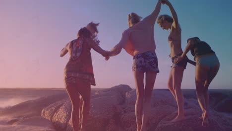 animation of light and shapes moving over diverse group of friends at beach