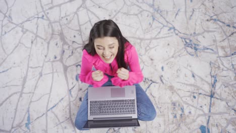 Mujer-Joven-Feliz-Y-Positiva-Usando-Una-Computadora-Portátil-Y-Regocijándose.-Mujer-Apasionadamente-Regocijada.