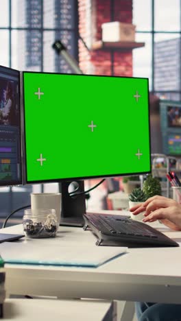 vertical video woman video creator edits a multimedia project next to chroma key