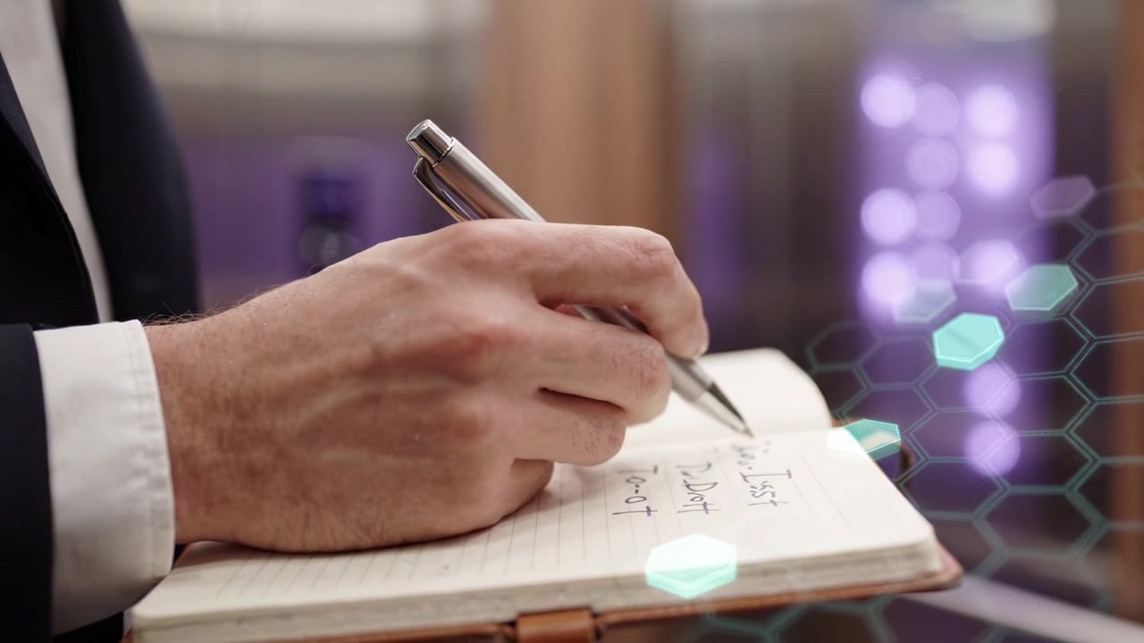 A Professional Hand Writing Notes in a Notebook While Standing in an Elevator, Signifying Organization and Productivity in a Busy Environment.