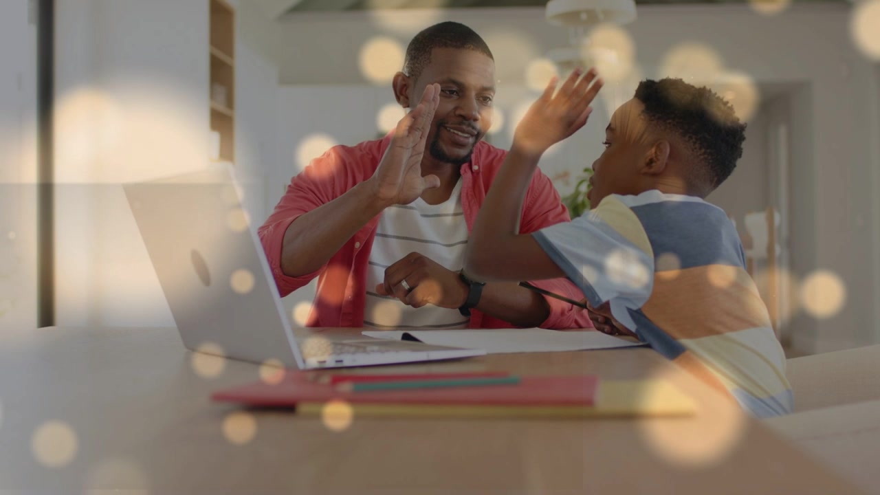 Dad raising hand inviting highfiving, son reaching, cheering study with laptop notes, bokeh overlay