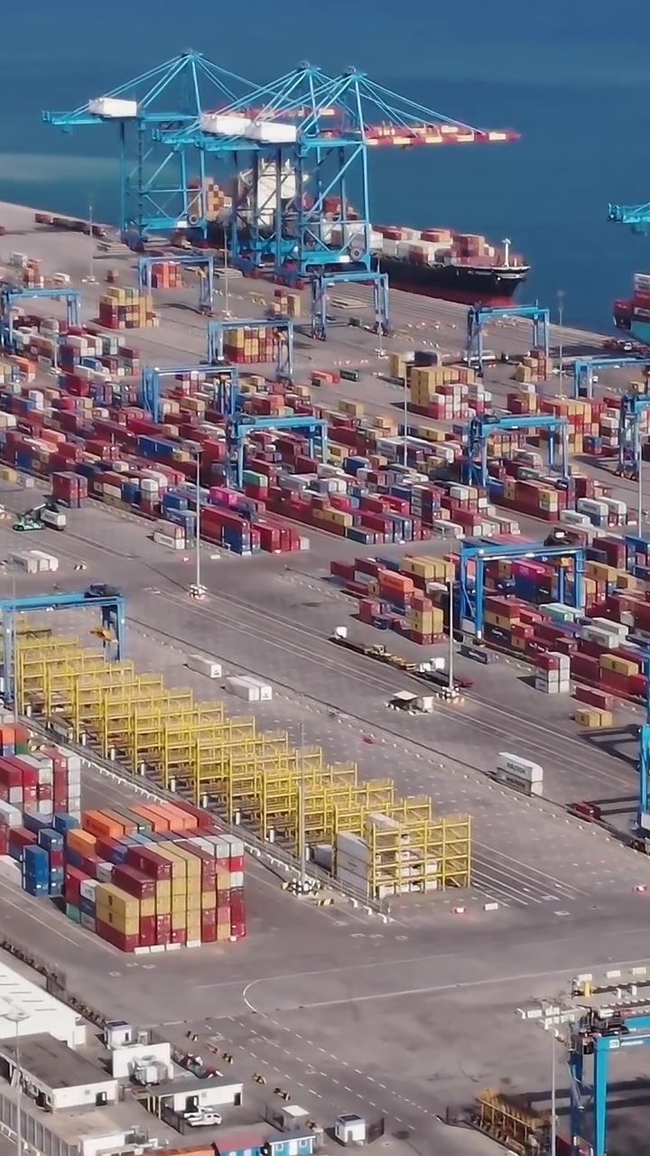 Large cargo port in Accra, Ghana with many shipping containers and cranes