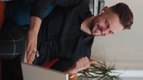 Guy-sitting-on-home-couch,-looking-at-camera,-making-video-conference-call-with-friends-or-family