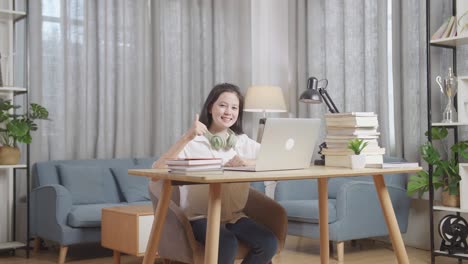 teenage girl doing online learning at home