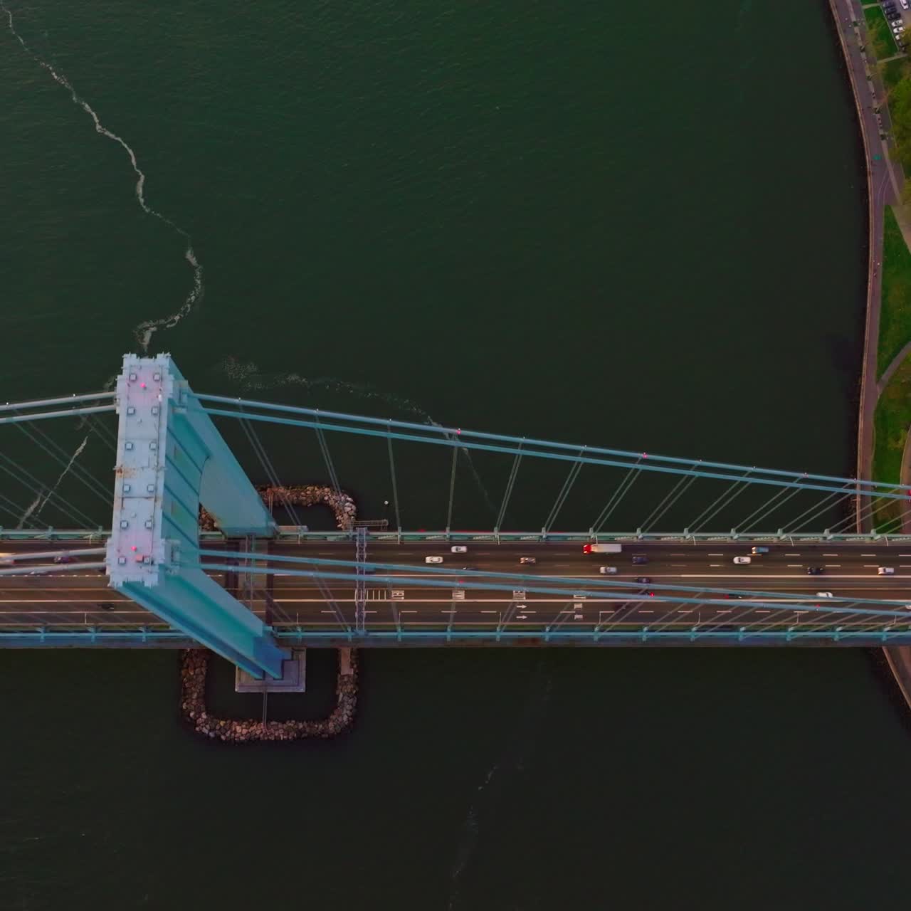 The Bronx-Whitestone bridge over the East River. Flying high above the bridge construction with cars passing through it