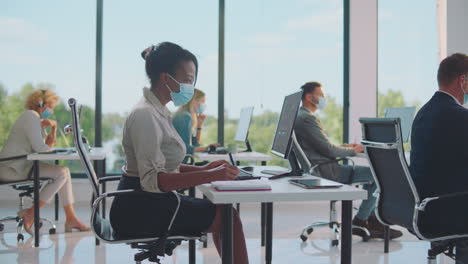 business team working in modern office space with covid protocols