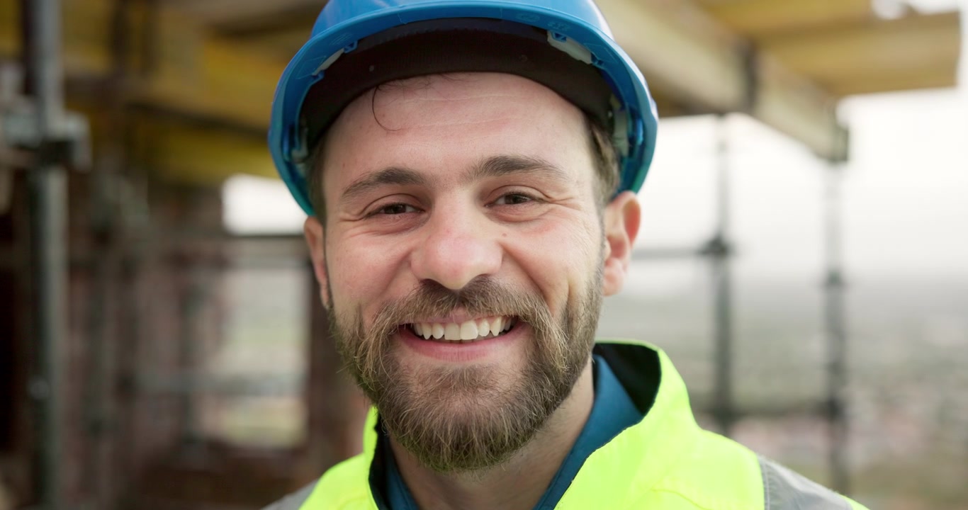 Portrait of a Smiling Construction Worker on a Building Site