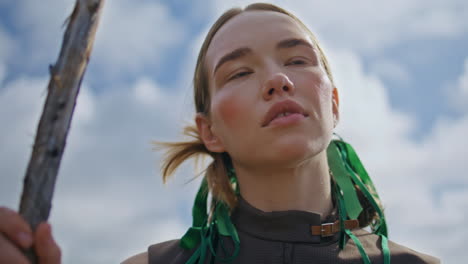 brave woman posing outdoors at cloudy sky closeup. fashion girl warm in sunlight