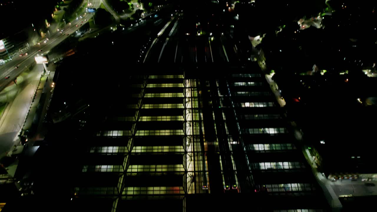 Revealing Aerial Tilt Up of Constitucion Square Station Terminal at Night, Buenos Aires