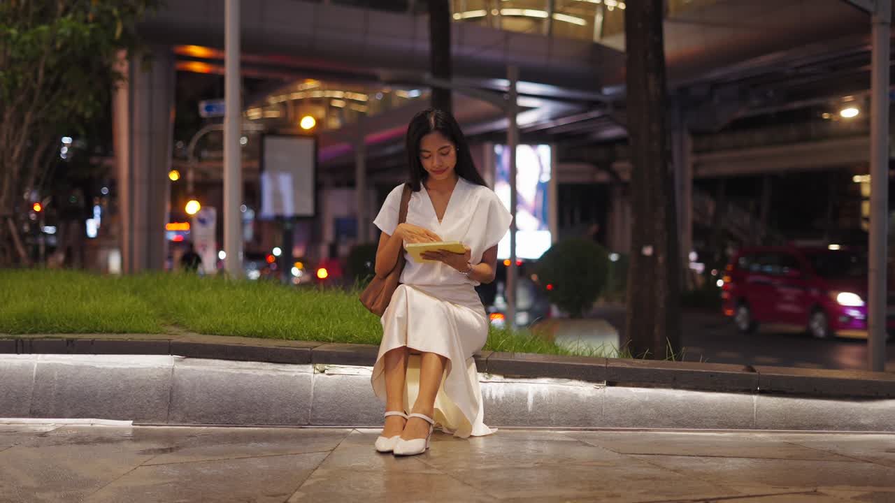 Woman Reading Tablet at Night in City