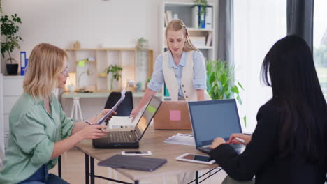 three women start working, discuss sales results