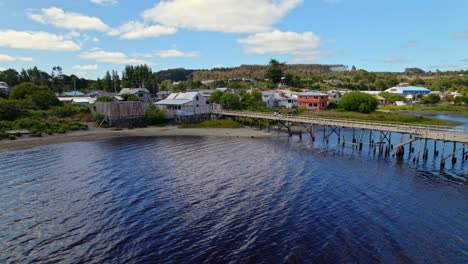 drone shot over a small dock in a locality of chiloe, huillinco, chile