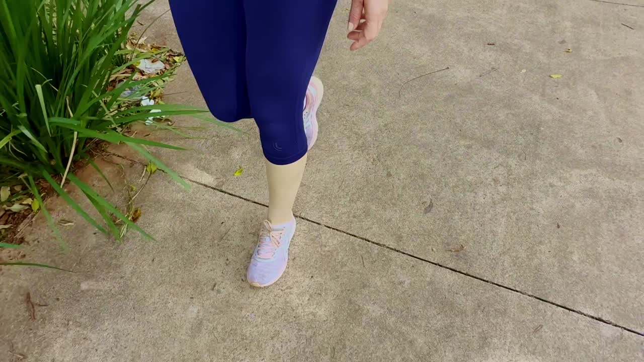 Close-up view, sunshine shade pavement scene, female sneakers fashion