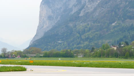glider sailplane makes final turn for landing at mountainous airport