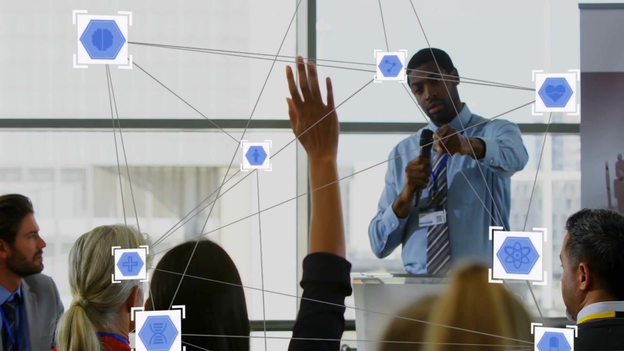 Host at clear lectern talking as woman raising hand asking, nodes forming linking business team