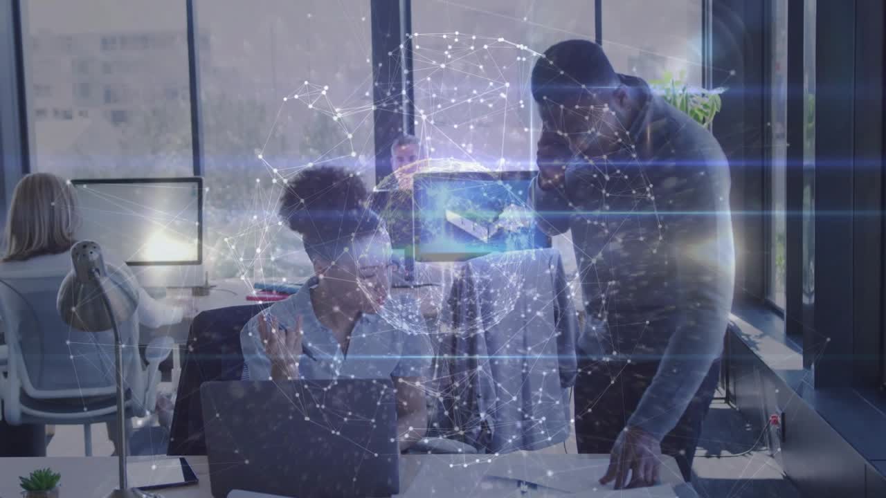 Seated woman, standing man ending call, arranging papers on laptop while globe pulsing in business