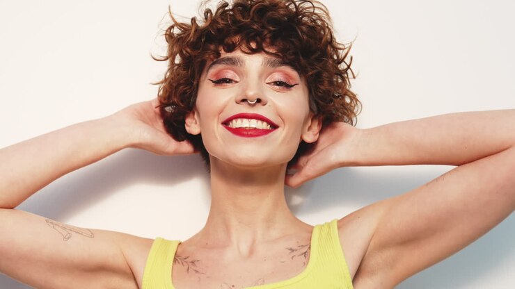 Smiling Woman with Curly Hair and Tattoos