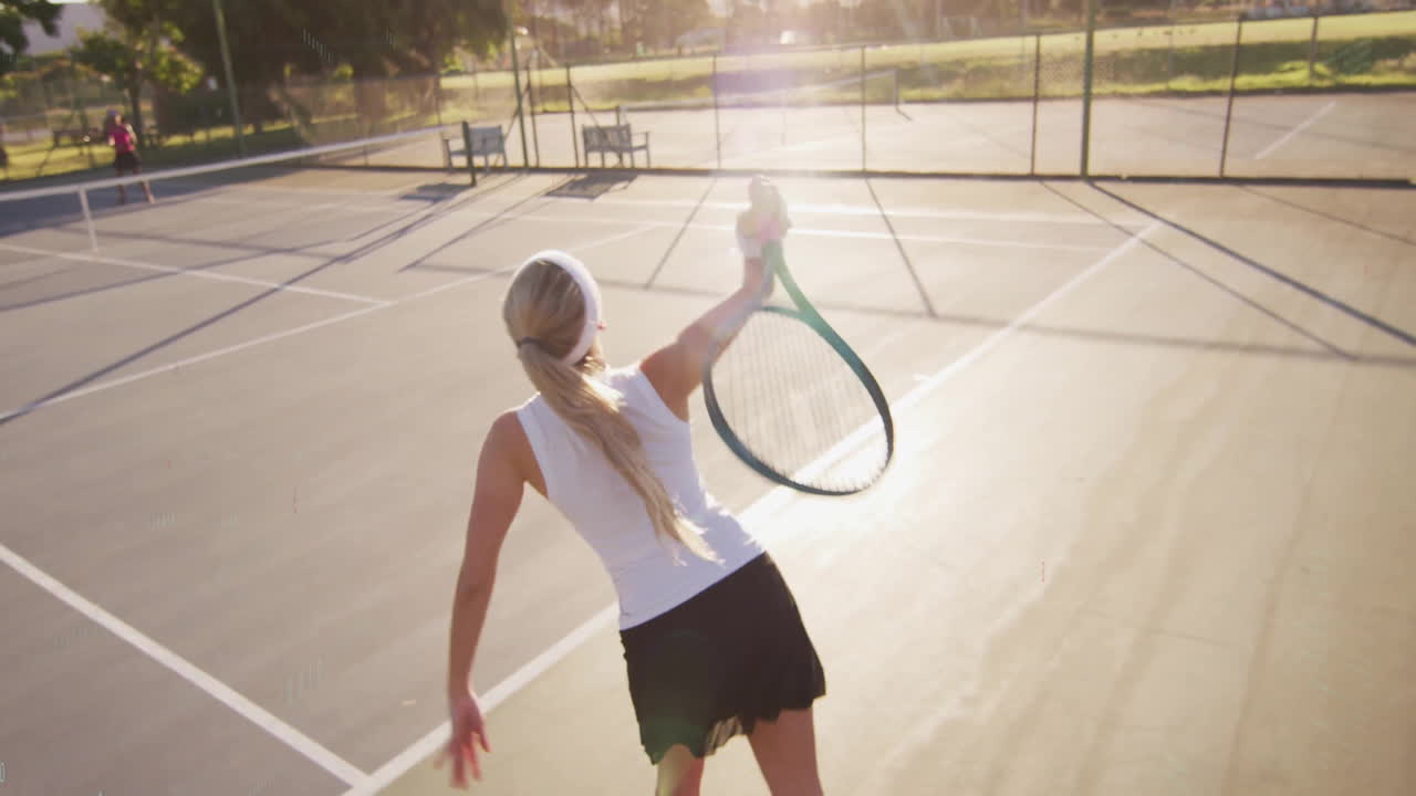Female tennis player serving ball on sports court, showing animated trajectory and score graphic