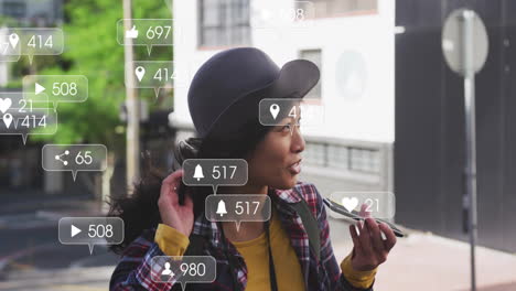 social media interaction icons animation over woman talking on smartphone outdoors