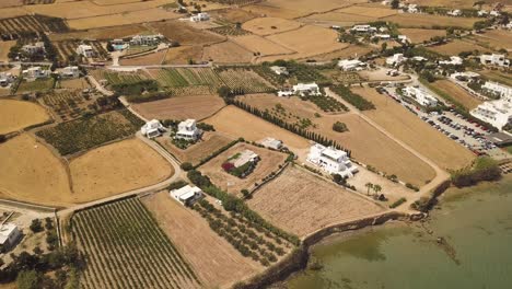 establishing drone tilt shot from the paros island coastline to the inland hills