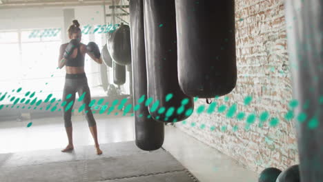 woman practicing boxing in gym with digital data animation overlay