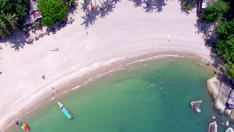 An-overhead-aerial-drone-shot-of-Haad-Than-Sadet-beach-located-at-Koh-Phangan-East-Coast,-in-the-south-of-Thailand